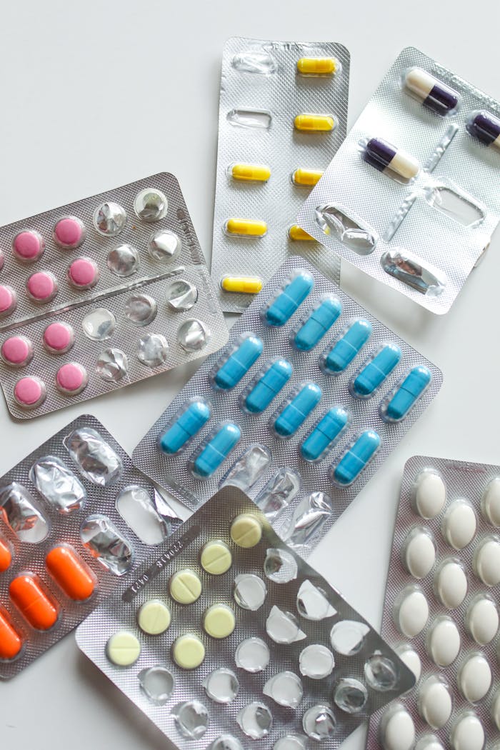 Various colorful medicine tablets in blister packs, emphasizing healthcare and pharmaceutical concepts.