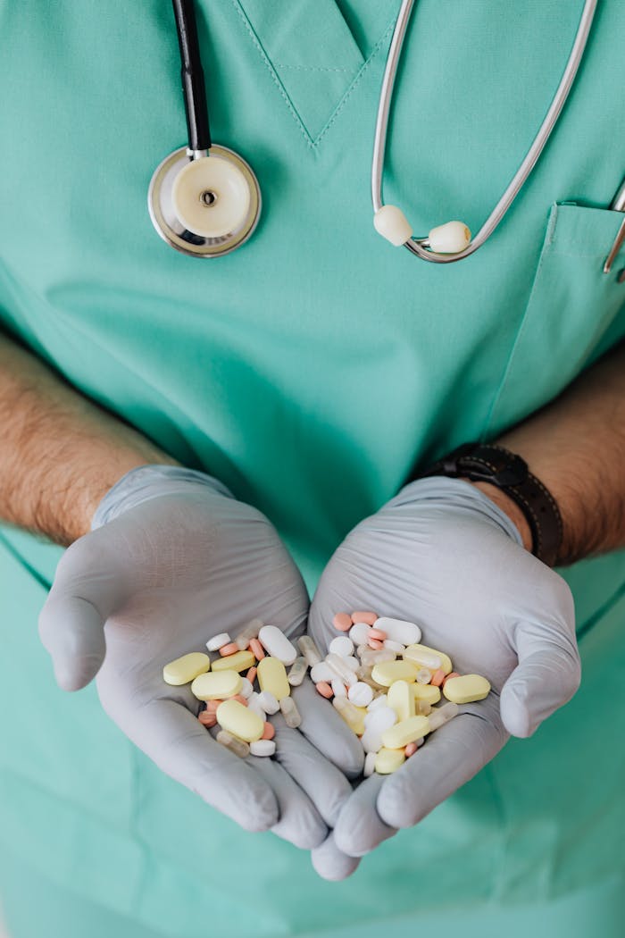 creative-03 Medical professional in scrubs holds various pills, symbolizing healthcare and medicine.